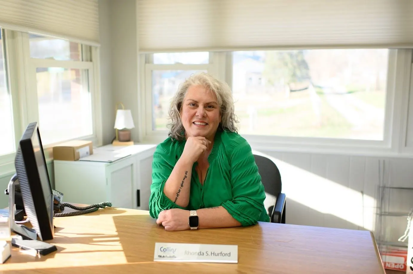 Rhonda Hurford at her desk in the Koontz Lake Collins & Company Realtors office